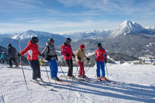 a group of skiers standing on top of a mountain at Landhaus Almidyll in Seefeld in Tirol