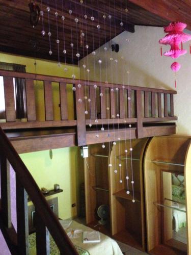 a room with a staircase with chandeliers hanging from it at Rancho Maria Pimenta in Joanópolis