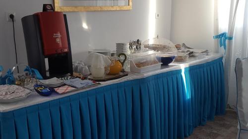 a table with a blue table cloth on it at Mata's Apartments in Tinos Town