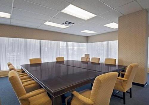 a conference room with a large table and chairs at Econo Lodge in Smiths Falls