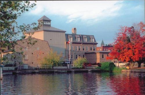 a large building next to a body of water at Econo Lodge in Smiths Falls
