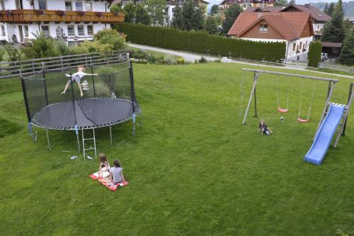 a group of children playing on a trampoline at Villa Castelli in Schladming