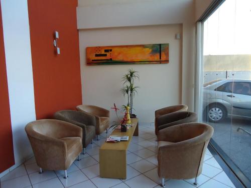 a waiting room with chairs and a table in a building at Colorado Plaza Hotel in Rio Verde