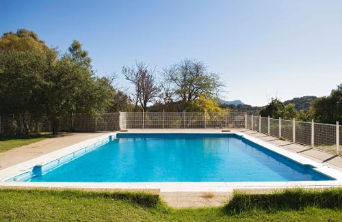 una piscina en un patio con una valla en Albergue Inturjoven Cortes De La Frontera en Cortes de la Frontera
