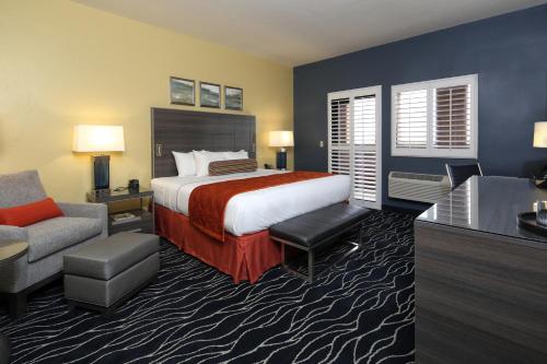 a hotel room with a bed and a chair at Desert Diamond Casino in Tucson