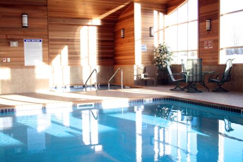 a large swimming pool in a hotel room at Super 8 by Wyndham Rogers Minnesota in Rogers