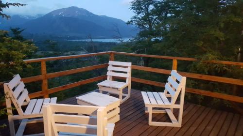 two chairs on a deck with a view of a mountain at Pendientes de Moquehue in Moquehue
