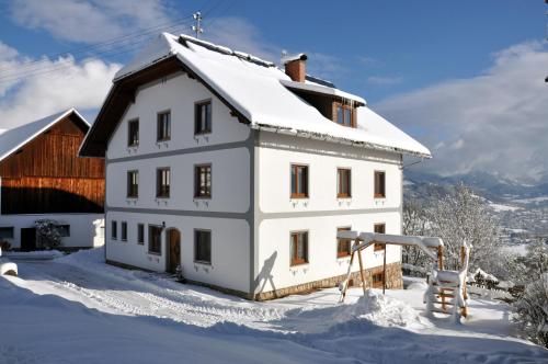 a white house with snow on top of it at Ferienhof Berger in Rossleithen