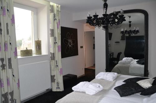 a bedroom with two beds and a large mirror at Au Petit Manoir in Socx