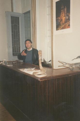 a man standing behind a desk with a mirror at Berlin Hotel in Cairo