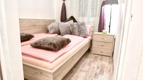 a bedroom with two beds with pink sheets and pillows at SpongeBob Apartment in Vienna