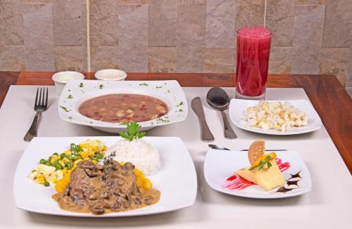 a table with three plates of food on it at Kuna Hotel in Cuenca