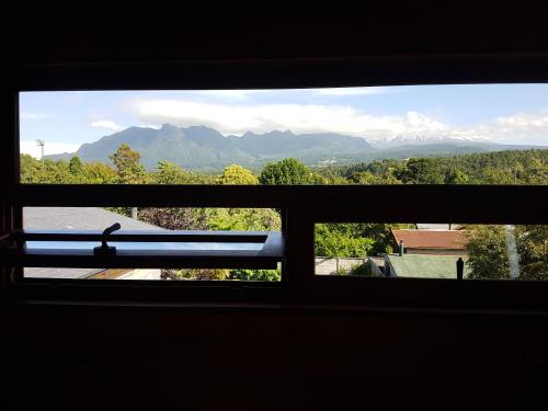 a view from a window of a mountain view at B&B de German in Pucón
