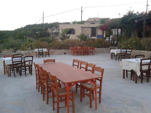 a group of tables and chairs with tables and tablesktop at Gavdos Princess in Gavdos