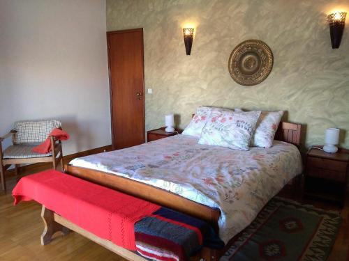 a bedroom with a bed with a red blanket on it at Laurel Beach House in Lourinhã