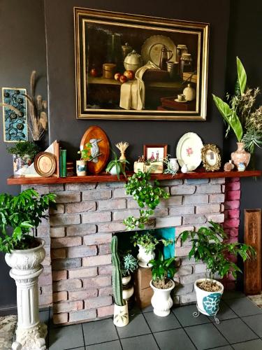 a brick fireplace with plants on top of it at Vine Valley Inn in Cessnock