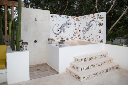 a white bathroom with a tub and some stairs at Luxury Private Villas , Private Pool, Private garden, Jacuzzi, 24hours security in Tulum