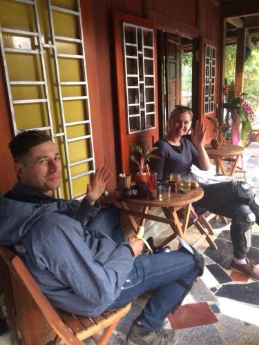 a man and a woman sitting at a table at Green Hill Hostel & Tour in Ha Giang