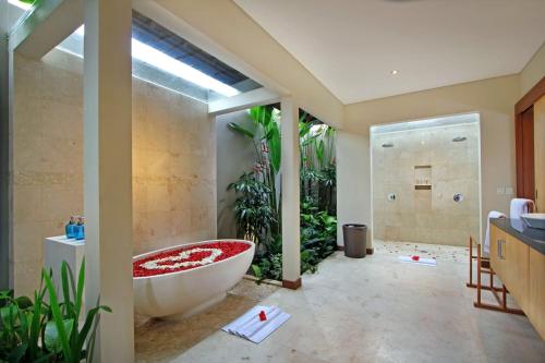 a bathroom with a large tub and a shower at Desa Di Bali Villas in Kerobokan