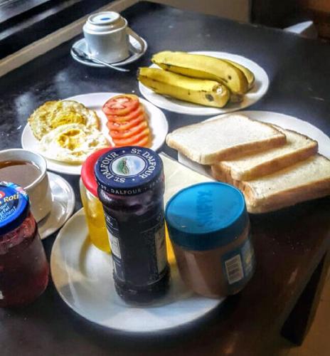 a table topped with plates of eggs bread and toast at Dago Teuku Angkasa 14 in Bandung