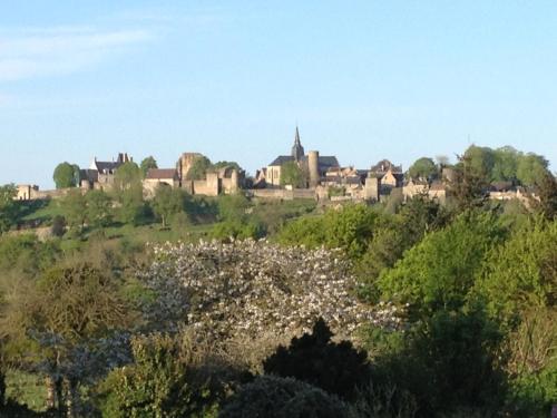 a town on top of a hill with trees at Ecrin de Verdure in Sainte-Suzanne