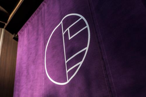 a d sign on top of a purple curtain at Hotel Kuu Kyoto in Kyoto