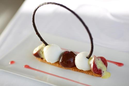 a dessert with chocolate and marshmallows on a plate at Hôtel Le Bailli De Suffren in Rayol-Canadel-sur-Mer