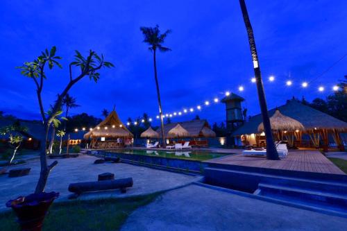a night view of a resort with lights at Beranda Ecolodge in Gili Air