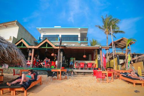 a group of people sitting on chairs on the beach at Funky Hotel in Hikkaduwa