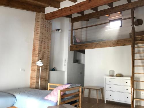 a bedroom with a loft bed and a dresser at Casa La Abuela in Chulilla