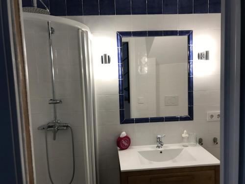 a bathroom with a sink and a shower with a mirror at Casa La Abuela in Chulilla