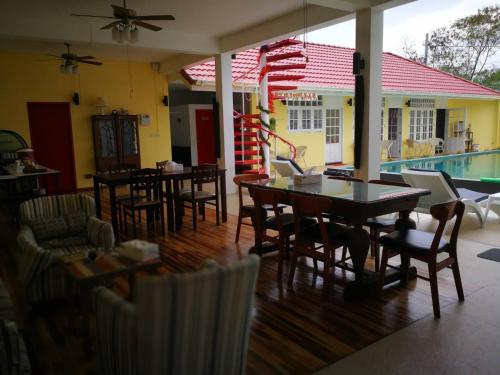 a restaurant with tables and chairs and a swimming pool at Barefeet Naturist Resort in Bangkok