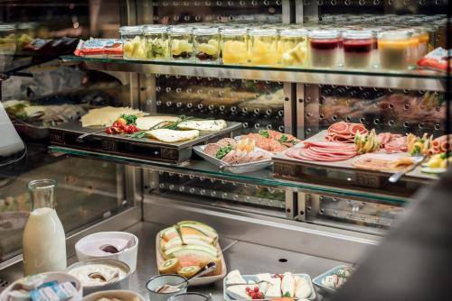 a display case with many different types of food at Underdog Hotel in Hamburg
