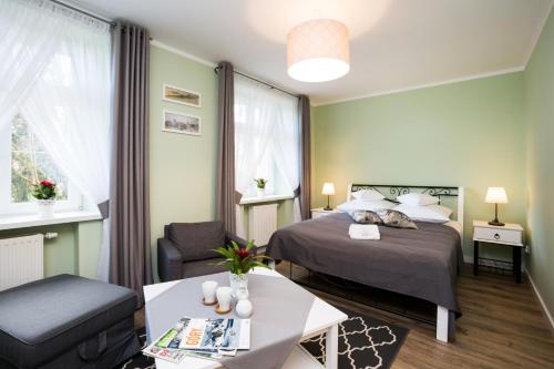 a small hotel room with a bed and a table at Apartamenty Bystra in Bystra