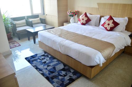a bedroom with a large bed and a table at Hotel Royal Palace in Bishnāth