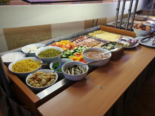 a buffet of different types of food on a table at Park Hotel Latgola in Daugavpils