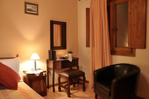 a bedroom with a bed and a chair and a desk at Anatoli Labreon in Agia Marina