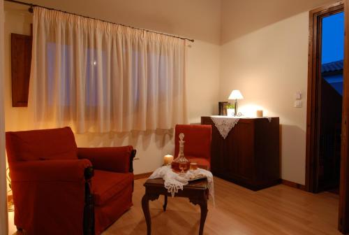 a living room with two chairs and a table at Anatoli Labreon in Agia Marina