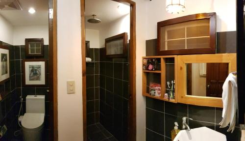 a bathroom with a sink and a toilet and a mirror at Stay Amare Villa Maria 1 in Bacolod