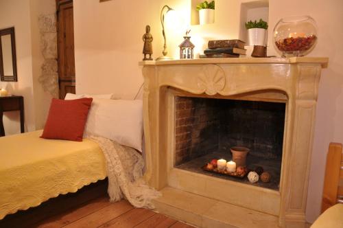 a living room with a fireplace with candles in it at Anatoli Labreon in Agia Marina