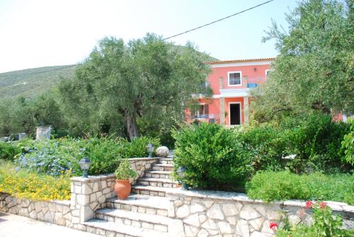 a house with a garden with a stone wall at Anatoli Labreon in Agia Marina
