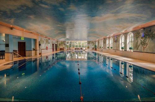 a large swimming pool with a ceiling with a sky at Citywest Hotel in Citywest