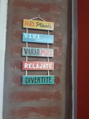a group of signs on a brick wall at Complejo M&M in Bialet Massé