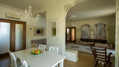 a kitchen and dining room with a white table and chairs at Private Villa First line with sea view in BlackSeaRama Golf A PLUS LOCATION PRIVACY POOL in Balchik