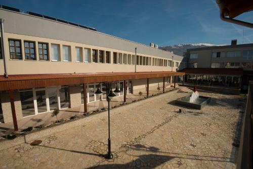 a large building with a courtyard in front of it at Hotel Village in Ohrid