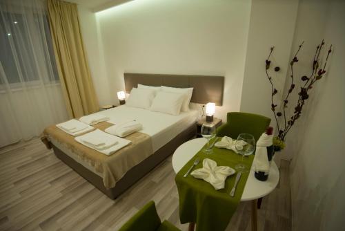 a hotel room with a bed and a table with a tableasonable at Hotel Village in Ohrid