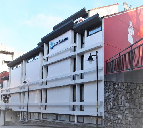 a building with a sign on the side of it at Havly Hotell in Stavanger
