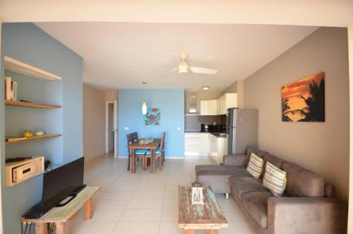a living room with a couch and a table at Dushi Pietermaai Apartments, DPA in Willemstad