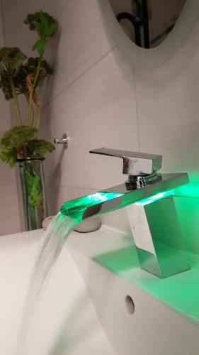 a water faucet with water coming out of it at Apartment Wave -Luxury massage chair-Infrared Sauna, Parking with video surveillance, Entry with PIN 0 - 24h, FREE CANCELLATION 24 hours before Check In, Premium pillows and mattress in Slavonski Brod