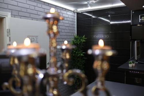 a group of lights in a room with black tiles at Hotell Marieberg in Kristinehamn